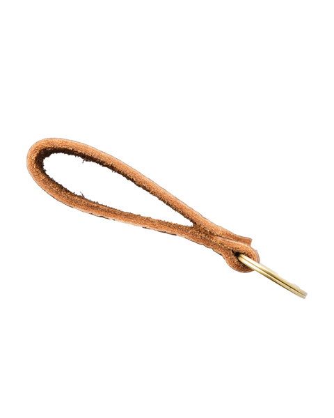 The Homestead Brand Bison Standard Key Fob No. 1603 is a brown full-grain leather keychain loop with a brass key-shaped hook, shown against a black background.