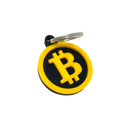 The Chatelet Manufacturing Bitcoin Keychain is a round, black decorative keychain with a yellow border and raised Bitcoin symbol, attached to a silver ring—ideal for cryptocurrency fans and proudly made in the USA.