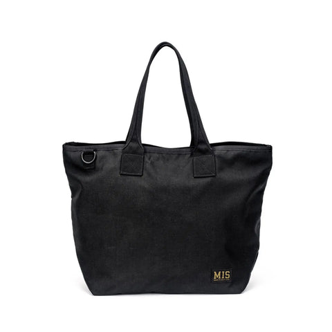 The MIS Tote Bag - Black is made from water-resistant Cordura Nylon, featuring two handles, a small black metal ring near the top, and an MIS logo patch at the lower right corner. The design is plain and unadorned.
