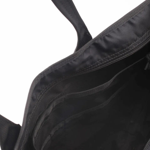 A close-up of the inside of the MIS Tote Bag - Black, made from Cordura Nylon, featuring a heavy-duty zipper and multiple inner pockets and compartments.