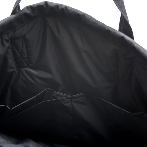 A close-up of the MIS UK Helmet Bag - Black shows its water-resistant Cordura Nylon build, multiple pockets, and reinforced handle stitching, highlighting the bags durable and well-crafted construction.