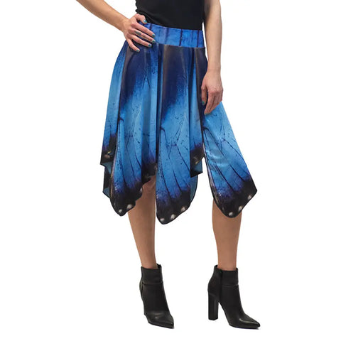 Only the lower half of the body is visible, showing a person in a black top, black ankle boots, and the Blue Morpho Butterfly Skirt by Spiritex | Sustainable Apparel with its signature asymmetric hem.
