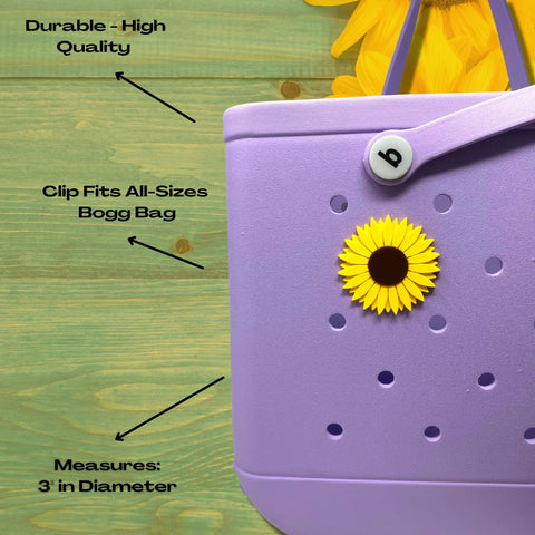 A close-up of a purple Bogg Bag features a Chatelet Manufacturing BOGLETS Flower Charm Accessory—a yellow sunflower (3 diameter) that’s durable, high quality, fits all-size Bogg Bags, and adds a cheerful touch with its sunflower petals.