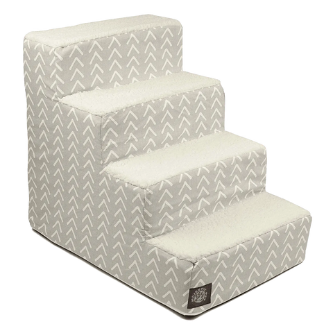 The Majestic Pet Boho Arrow 4 Steps Pet Stairs (Heavy-Duty) features a light gray and white arrow pattern, soft sherpa cushions, a machine-washable slipcover, and a bottom-step label—ideal for helping pets reach furniture.