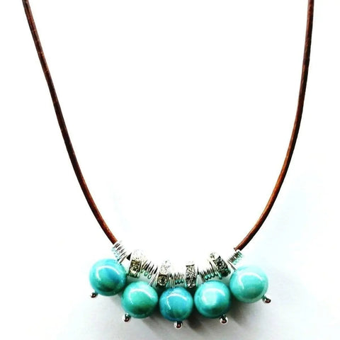 The Alexa Martha Designs Silver Green Blue Shell Bead Charm Leather Necklace features shell beads and silver accents on leather, showcased against a white background.