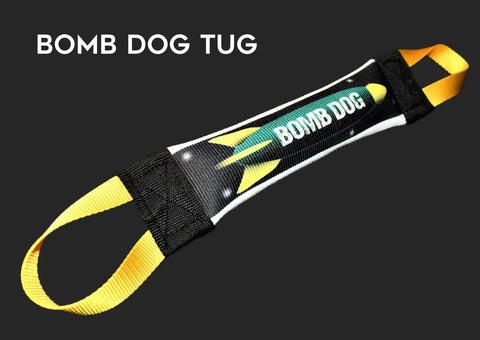Introducing the Bomb Dog Fire Hose Training Tug by Bulletproof Pet Products Inc—a durable dog tug toy with yellow handles, black ends, and a rocket graphic reading BOMB DOG at the center. Bomb Dog Tug appears in the top left corner.