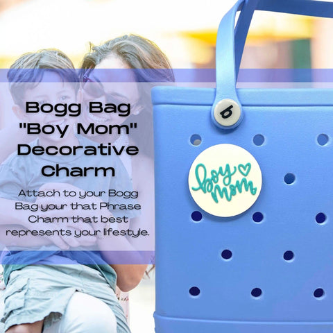 A woman holds a blue bag customized with the FRESHe BOGLETS Boy Mom Charm in teal and white by Chatelet Manufacturing, designed for decorating compatible Bogg Bags.