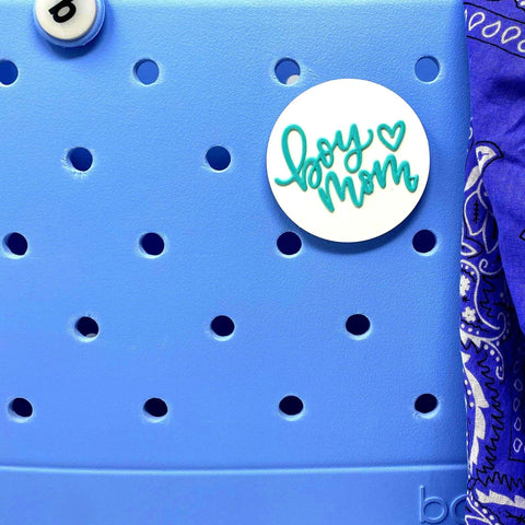 The FRESHe BOGLETS Boy Mom Charm by Chatelet Manufacturing features teal and white text and is perfect for customizing Bogg Bags or adding to other decorative bag charms.