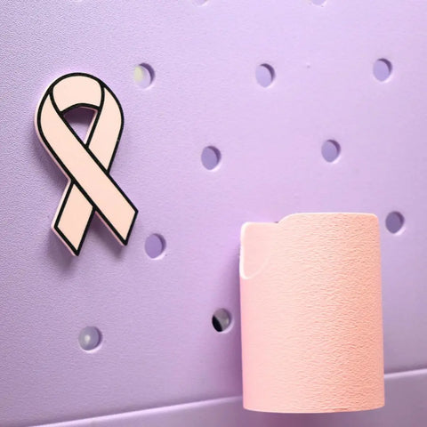 The Baglets - Pink Ribbon Charm by Chatelet Manufacturing is a breast cancer awareness accessory, featuring a pink ribbon charm and holder that attach easily to tote bags like Bogg Bags, Simply Southern, and more.