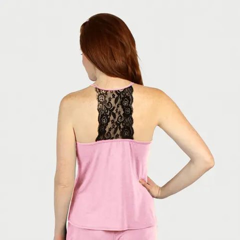 A woman with long red hair is seen from the back wearing the Goodnighties Lace Back Halter Top in pink, featuring a black lace panel. Her right hand rests on her hip, set against a plain light gray background.