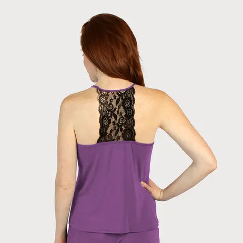 A woman with long red hair wears a purple Goodnighties Lace Back Halter Top, featuring black lace back detail. She stands facing away from the camera, one hand on her hip, against a plain light background.