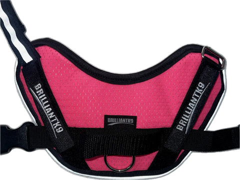 The BrilliantK9 Ergonomic Small Dog Harness 10 to 20 Lbs - Summer Mesh features a pink and black design, ergonomic fit, branded black straps and center label, reflective trim, and a metal ring for leash attachment.