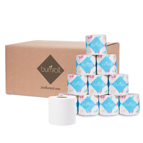 A cardboard box labeled Bumroll sits behind nine individually wrapped Bumroll Premium Toilet Paper rolls, each with colorful butterfly designs. One unwrapped roll is in front; every purchase plants trees in the USA.