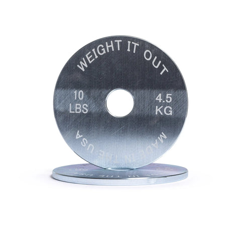 Two Solid Steel Calibrated Weight Plate Pairs from Weight It Out are shown—one upright with WEIGHT IT OUT, 10 LBS, 4.5 KG, MADE IN THE USA engraved, and another lying flat—perfect for your Olympic bar setup.