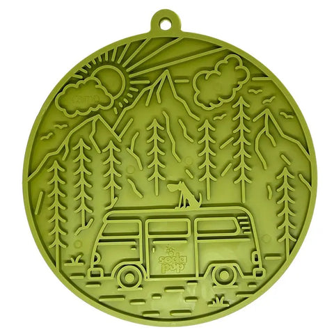 The SodaPup Camp Design EMat Enrichment Lick Mat With Suction Cups is a round, green silicone mat featuring a van, pine trees, mountains, sunrise, and “camp”—a perfect engaging lick mat for dogs.
