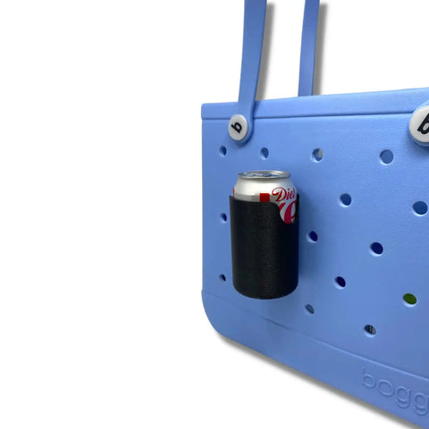 A light blue perforated rubber tote with a Chatelet Manufacturing FRESHe BAGLETS Can Drink & Water Bottle Holder Charm Accessory (fits Bogg Bags) holding a black can of Diet Coke, shown against a plain white background.