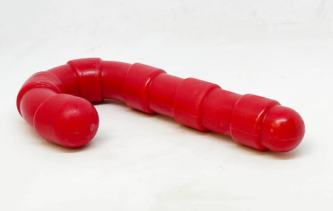 The SodaPup Candy Cane Ultra Durable Nylon Chew Toy, red and slightly curved with a rounded end, is designed for power chewers and shown against a white background.