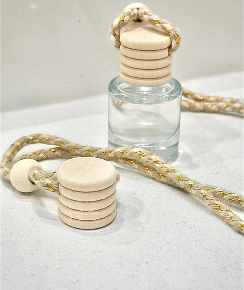The Car Diffuser Replacement Lid – USA-Made Accessory by Shanti + Tula features a wooden cap and beige braided rope with gold accents, perfect as a stylish replacement for your car diffuser.