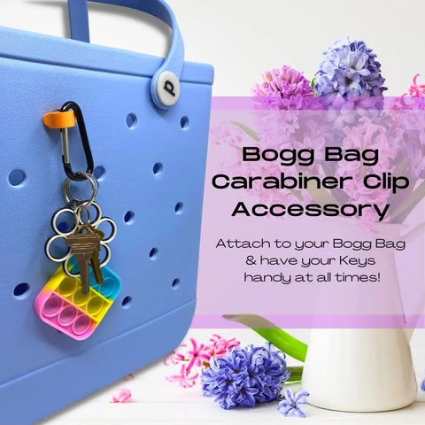 The Chatelet Manufacturing BAGLETS Carabiner & Plug Keys Holder Charm keeps keys secure on your rubber tote bag. Available in fun colors, it’s a must-have USA-made accessory that adds convenience and style.
