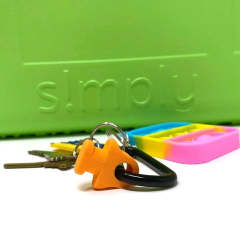 The BAGLETS Carabiner & Plug Keys Holder Charm by Chatelet Manufacturing is a colorful accessory for rubber tote bags like Bogg Bags. Secure your keys or valuables with this USA-made holder, shown with an orange plug charm and keychain.