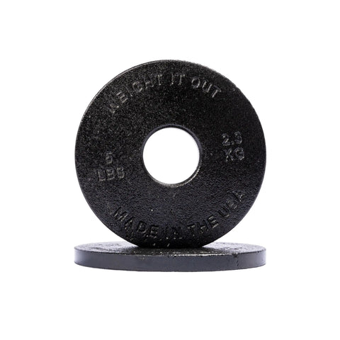 Two black Cast Iron Machined Weight Plate Pairs from Weight It Out are shown—one upright, one flat. The standing plate displays 5 LBS, 2.3 KG, MADE IN THE USA—perfect for Olympic bars and with minimal weight variance.