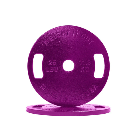 Two Weight It Out Cast Iron Machined Weight Plate Pairs in purple, each 25 LBS/11.3 KG, feature handles, textured surfaces, and a central hole for Olympic bars. One plate stands upright; the other lies flat below.