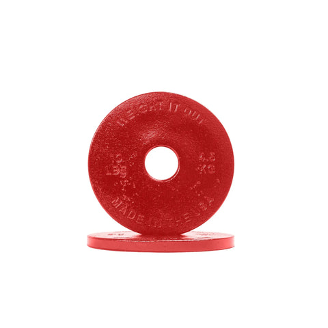 Two red Cast Iron Machined Weight Plate Pairs by Weight It Out are shown: one upright and one flat. The upright plate has a center hole, displays 4.5 KG and 10 LB, and fits Olympic bars—ideal for versatile workouts.