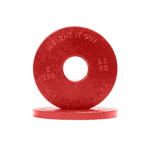 Two red Weight It Out Cast Iron Machined Weight Plate Pairs, one upright and one flat. Upright plate shows WEIGH IT OUT, 5 LBS, 2.3 KG, MADE IN THE USA. Designed for Olympic bars with minimal weight variance.