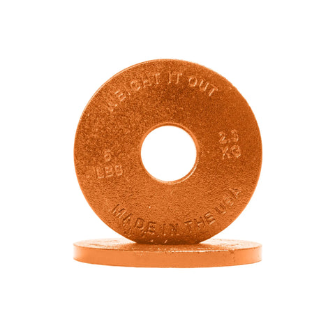 Two orange Cast Iron Machined Weight Plate Pairs by Weight It Out—one upright displaying “WEIGHT IT OUT, 5 LBS, 2.3 KG, MADE IN THE USA,” the other flat behind. Perfect for Olympic bars and engineered to minimize weight variance.