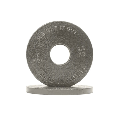 Two Cast Iron Machined Weight Plate Pairs by Weight It Out are shown—one upright, one flat. The upright plate is labeled 5 LBS, 2.3 KG, WEIGHT IT OUT, MADE IN THE USA. Designed for Olympic bars, both plates rest on a white surface.