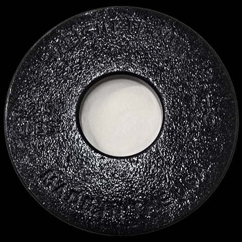 A black, textured, circular Weight It Out cast iron plate with a large center hole and embossed 2.5 LBS and MADE IN U.S.A. text—ideal for Cast Iron Weight Plate Sets.