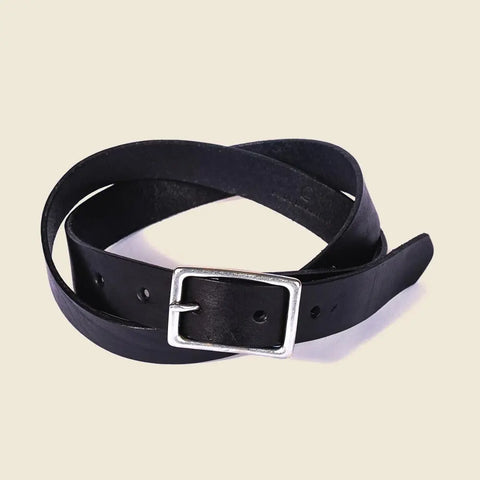 The CASUPO Smith Thinner Belt Black, featuring a handcrafted leather design and a silver rectangular buckle, is coiled loosely on a plain beige background.