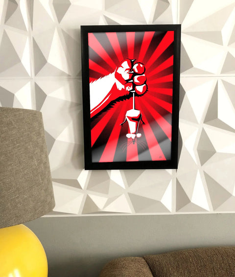 The Cat Fist poster by Skinny Petes Gourmet Catnip features a stylized fist holding a chess piece with red and white rays, framed and displayed on a geometric-patterned white wall above a couch near a yellow-base lamp.