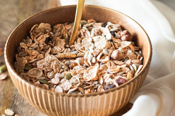 Bowl of muesli with a spoon, on a light background