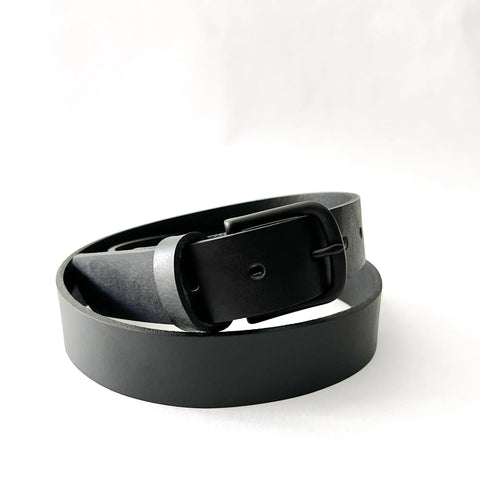 The Chamberlain Leather Belt by Rogue Industries, 1.25 wide, features a matte black metal buckle and is shown coiled neatly on a white background.