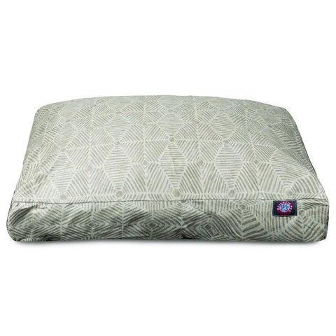 The Charlie Rectangle Dog Bed by Majestic Pet is a light gray cushion with a geometric diamond and leaf pattern, featuring a small blue and red logo patch and a removable cover for easy cleaning.