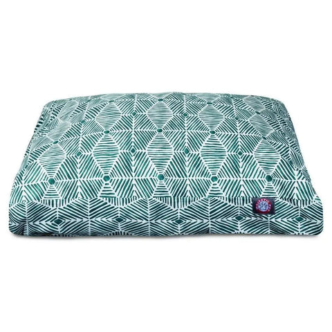 The Charlie Memory Foam Dog Bed by Majestic Pet is a rectangular, washable dog bed with a teal and white geometric pattern of repeating diamonds and lines, and features a small logo tag in one corner.