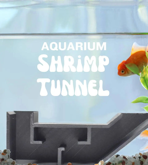 A goldfish swims by the black Chatelet Aquarium Underground Tunnel from Chatelet Manufacturing—a unique L-shaped 3D-printed fish & shrimp hideout. Bold text reads Aquarium Shrimp Tunnel. Pebbles below enhance your aquarium décor. Made in USA.