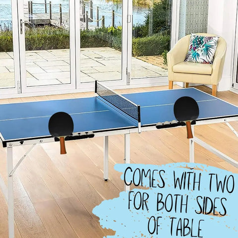 The Chatelet Ping Pong Table Caddy (Pack of 2) by Chatelet Manufacturing holds paddles on both sides of your blue table tennis table, perfect for a bright room with wood floors, floral-cushioned chair, and large windows overlooking a deck and water view.