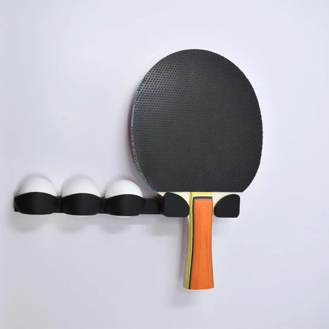 The Chatelet Ping Pong Table Caddy by Chatelet Manufacturing (Pack of 2) holds a table tennis paddle with black rubber and four white balls, all neatly organized against a white background.