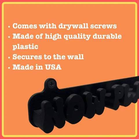 The Chatelet Groovy Now Playing Vinyl Record Wall Mount by Chatelet Manufacturing is shown in black with bold NOW-PL text. Features listed on an orange background: includes drywall screws, durable plastic, wall-secured, made in USA.