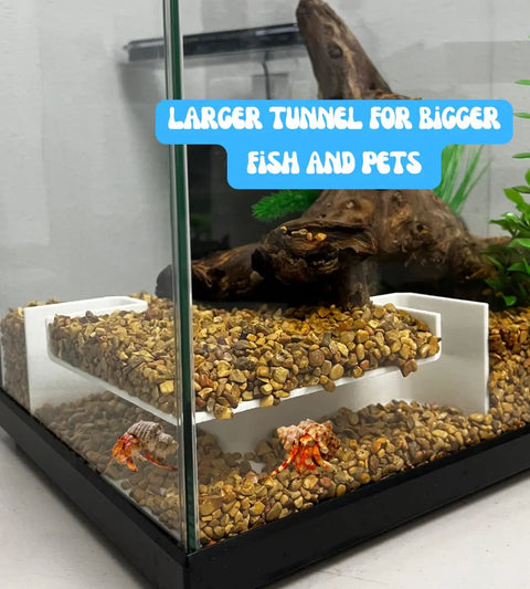 A fish tank with gravel, plants, driftwood, hermit crabs, and a Chatelet Aquarium Underground XL Corner Tunnel by Chatelet Manufacturing. Blue text reads: Larger tunnel for bigger fish & pets.