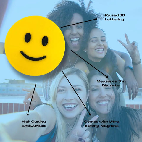 Four smiling women pose for a selfie outdoors. Featured is the Emoji Smiley Face decorative standalone ideogram by Chatelet Manufacturing—black and yellow, made in the USA—perfect as a unique 3D printed magnet or fun emoji gift.