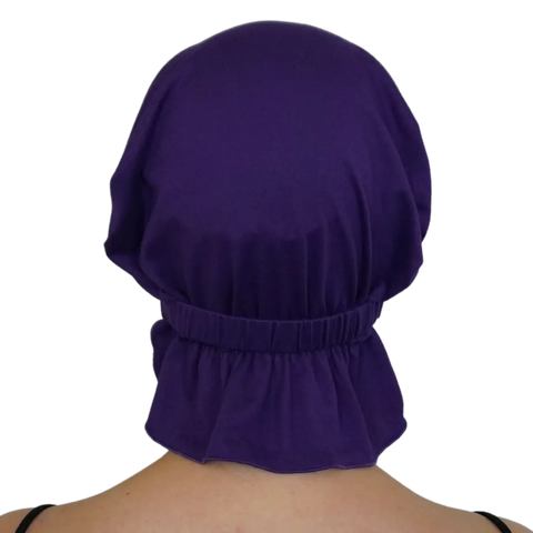 A person seen from behind wears a loose-fitting Chemo Beanies® Scarves - Chemo Beanies® in Violet, featuring gathered elastic at the neck. Their shoulders and upper back are partially visible.