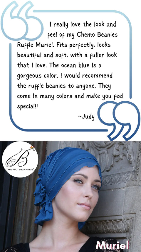A woman in a blue ruffled Chemo Beanies® Muriel scarf leans against a wall. Above her, a testimonial praises its look, feel, color, and fit, with the Chemo Beanies® logo and Muriel’s name below.