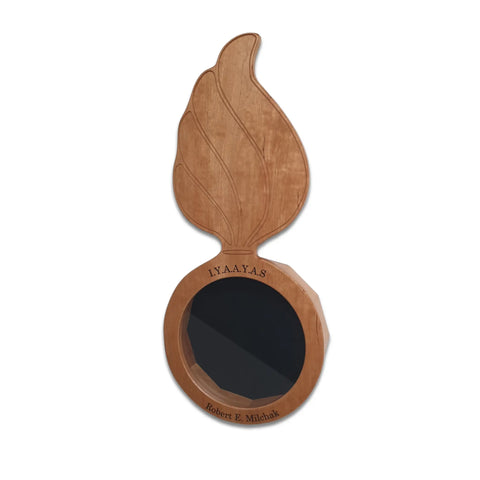 The Cherry Ammo Pisspot Shadow Box by Legacies of America Woodworking Company is a cherry hardwood plaque shaped like a winged emblem with a black center. “I.Y.A.A.Y.A.S” is inscribed on top and “Robert E. Michlak” on the bottom. Made in USA.