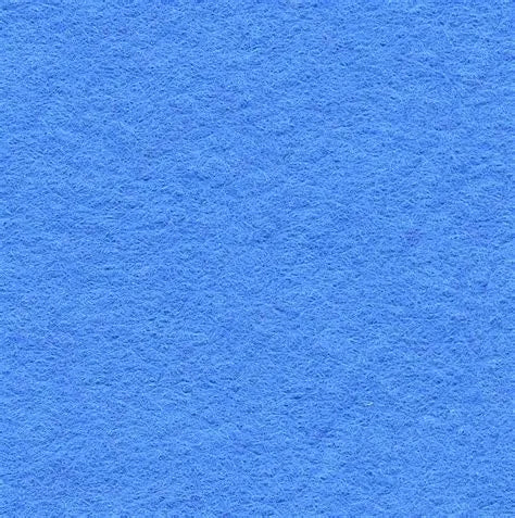 A close-up of the Cherry Ammo Pisspot Shadow Box by Legacies of America Woodworking Company, made in the USA by veterans, shows its textured blue felt surface with fine, soft fibers and a vibrant, consistent blue color.