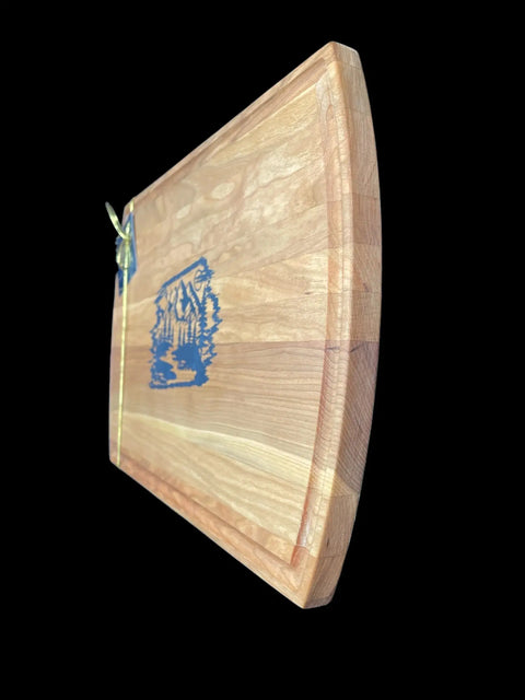 The Blue Steel Epoxy Inlay Cherry Serving Tray by B. James Design & Woodwork features grooved outer edges and a striking blue steel epoxy inlay at the center, accented with a small gold ribbon, shown against a black background.