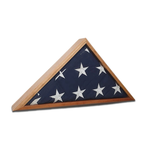 A folded 5 x 9.5 American flag with white stars is displayed in the Cherry Burial Flag Display Case by Legacies of America Woodworking Company, handcrafted in the USA and showcased against a white background.