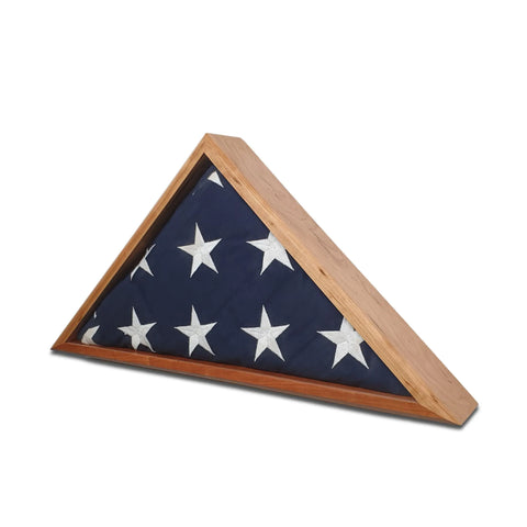 A folded American flag with white stars is displayed in the Cherry Burial Flag Display Case (5 X 9.5), handcrafted in the USA by Legacies of America Woodworking Company.